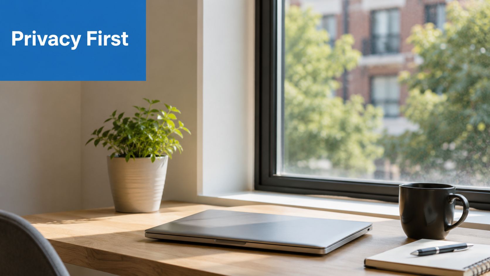 A clean, modern home office desk with a closed laptop, a small potted plant, and a coffee mug.